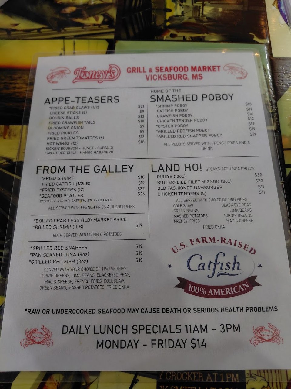 Printed menu with grilled seafood and burger options.